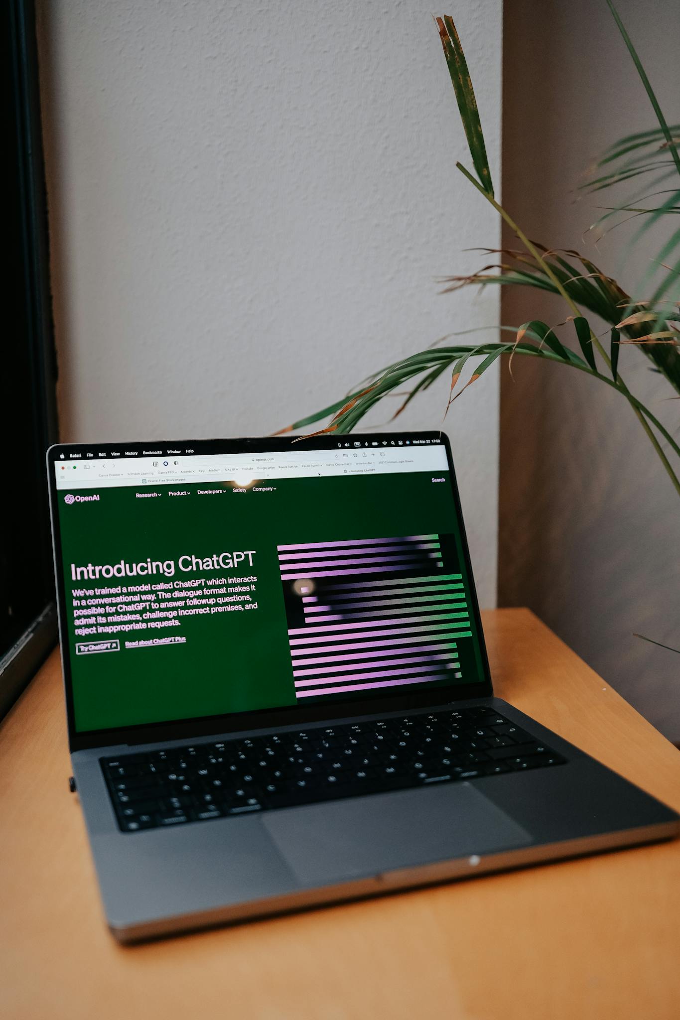 A laptop on a desk showing a ChatGPT interface, symbolizing modern AI technology in daily use.